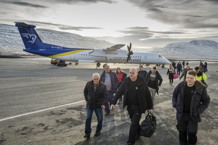 A group of people coming off an aeroplane at Akureyri Airport.